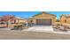 A single-story home with easy-care desert landscaping and convenient two-car garage at 4399 Luciano Ave, Pahrump, NV 89061