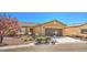 Charming single-story home with desert landscaping, a two-car garage, and a lovely tree in the front yard at 4399 Luciano Ave, Pahrump, NV 89061