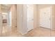 Hallway featuring tile floors and multiple doorways, offering a bright and spacious feel at 4399 Luciano Ave, Pahrump, NV 89061