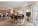Inviting kitchen and dining area with stainless steel appliances, a breakfast bar, and sliding doors to a backyard at 4399 Luciano Ave, Pahrump, NV 89061