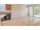 Bright kitchen and living area combo with granite countertops, neutral paint, and patio access at 4399 Luciano Ave, Pahrump, NV 89061