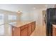 Modern kitchen island with granite countertops, cabinetry, and stainless steel refrigerator in the view at 4399 Luciano Ave, Pahrump, NV 89061