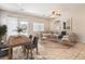 Comfortable living room and dining area with neutral furniture, tile floors, and a sliding door to the backyard at 4399 Luciano Ave, Pahrump, NV 89061