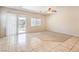 Bright living room with tile floors, a sliding glass door, and natural light streaming through at 4399 Luciano Ave, Pahrump, NV 89061
