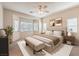 Serene bedroom with a bay window, neutral tones, carpet floors, and a ceiling fan, creating a relaxing retreat at 4399 Luciano Ave, Pahrump, NV 89061