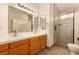 Bathroom featuring double sinks, a walk-in shower, and tile floors at 4405 Testarossa Ln, North Las Vegas, NV 89081