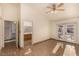 A primary bedroom features tiled floors and double door access to the bathroom and outdoor seating area at 4405 Testarossa Ln, North Las Vegas, NV 89081