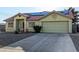 Attractive single-story home featuring a two-car garage, desert landscaping, and a tile roof at 4405 Testarossa Ln, North Las Vegas, NV 89081