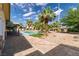 Backyard patio leading to a luxurious pool surrounded by palm trees at 4678 Saddle Pl, Las Vegas, NV 89119