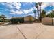 Spacious backyard with a large paved area, mature trees, and a storage shed at 4678 Saddle Pl, Las Vegas, NV 89119