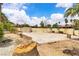 Large backyard with shed, brick features, and mature trees under a blue sky at 4678 Saddle Pl, Las Vegas, NV 89119