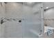 Beautiful walk-in shower with gray tiles and decorative mosaic trim, and a tub beside the shower at 4678 Saddle Pl, Las Vegas, NV 89119