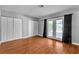 This bedroom features wood floors, three closets and french doors to the backyard at 4678 Saddle Pl, Las Vegas, NV 89119