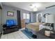 Comfortable bedroom with neutral tones, ample natural light, and tiled floors at 4678 Saddle Pl, Las Vegas, NV 89119