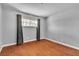 Well-lit bedroom featuring hardwood floors and a window with curtains, creating a cozy atmosphere at 4678 Saddle Pl, Las Vegas, NV 89119