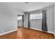 This bedroom features wood floors, neutral walls, natural light from the window, and a mirrored closet at 4678 Saddle Pl, Las Vegas, NV 89119