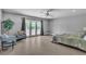 Spacious bedroom with tiled floors, a ceiling fan, and a private access to the backyard at 4678 Saddle Pl, Las Vegas, NV 89119