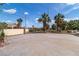 Large, paved driveway with ample parking space, surrounded by mature landscaping and palm trees at 4678 Saddle Pl, Las Vegas, NV 89119