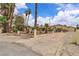 Spacious property with tall palm trees and a gated driveway at 4678 Saddle Pl, Las Vegas, NV 89119