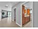 Well-lit hallway with tiled floors leading to a bathroom and living area at 4678 Saddle Pl, Las Vegas, NV 89119