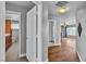 Bright hallway featuring hardwood floors, neutral paint, and updated lighting fixtures at 4678 Saddle Pl, Las Vegas, NV 89119
