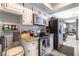 Galley kitchen with stainless appliances, white cabinetry, and modern backsplash at 4678 Saddle Pl, Las Vegas, NV 89119