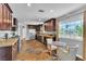 Bright kitchen featuring stainless steel appliances, stone countertops, and an eat-in dining space at 4678 Saddle Pl, Las Vegas, NV 89119
