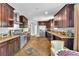 Bright kitchen featuring stainless steel appliances, stone countertops, and an eat-in dining space at 4678 Saddle Pl, Las Vegas, NV 89119