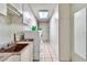 Functional laundry area with a sink, washer, dryer, and ample cabinet space at 4678 Saddle Pl, Las Vegas, NV 89119
