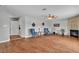 Bright living room with hardwood flooring, a fireplace, and comfortable seating at 4678 Saddle Pl, Las Vegas, NV 89119