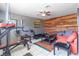 Cozy living room featuring unique wood accent wall and bright contemporary furnishings at 4678 Saddle Pl, Las Vegas, NV 89119