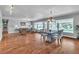 Spacious living room featuring hardwood floors, recessed lighting, and large windows bringing in natural light at 4678 Saddle Pl, Las Vegas, NV 89119
