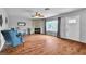 Bright and open living room features hardwood flooring, a stone fireplace, and large windows at 4678 Saddle Pl, Las Vegas, NV 89119