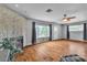 Bright living room with hardwood floors, a fireplace, and large windows at 4678 Saddle Pl, Las Vegas, NV 89119