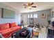 Cozy living room with tiled floors, bright sofa, and exercise equipment in view at 4678 Saddle Pl, Las Vegas, NV 89119