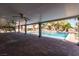 Covered patio overlooking a beautiful backyard pool and landscaping at 4678 Saddle Pl, Las Vegas, NV 89119