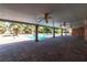 Spacious covered patio providing shade and views of a pool and palm-filled backyard at 4678 Saddle Pl, Las Vegas, NV 89119