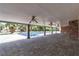 Covered patio with brick pillars and fans overlooking the pool and landscaping at 4678 Saddle Pl, Las Vegas, NV 89119