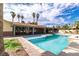 Backyard view of a sparkling pool with surrounding brickwork and covered patio at 4678 Saddle Pl, Las Vegas, NV 89119