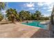 Inviting pool surrounded by a spacious patio and lush palm trees, perfect for outdoor entertaining at 4678 Saddle Pl, Las Vegas, NV 89119