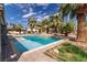Inviting pool area surrounded by palm trees and lush desert landscape at 4678 Saddle Pl, Las Vegas, NV 89119