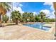 Backyard pool with brick-paver patio and lush tropical landscaping at 4678 Saddle Pl, Las Vegas, NV 89119