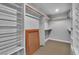 Spacious walk-in closet with built-in shelves, rods, and tiled floors for organized storage at 4678 Saddle Pl, Las Vegas, NV 89119
