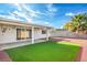 Backyard with a green lawn and a covered patio, perfect for outdoor entertaining at 5200 Longridge Ave, Las Vegas, NV 89146