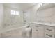 Modern bathroom with marble tile, soaking tub and shower, and stylish vanity at 5200 Longridge Ave, Las Vegas, NV 89146