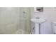 Modern bathroom features glass-enclosed shower, pedestal sink, and tile details at 5200 Longridge Ave, Las Vegas, NV 89146