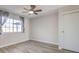 Bedroom features ceiling fan, window with curtains, and a closet with sliding doors at 5200 Longridge Ave, Las Vegas, NV 89146