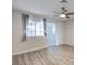 Bedroom features wood-look flooring, ceiling fan, window with stylish curtains, and ensuite bathroom at 5200 Longridge Ave, Las Vegas, NV 89146