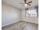 Spacious bedroom with gray curtains, a ceiling fan, and light-colored wood floors at 5200 Longridge Ave, Las Vegas, NV 89146