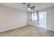 Bedroom features wood-look flooring, window with stylish curtains, and ensuite bathroom at 5200 Longridge Ave, Las Vegas, NV 89146
